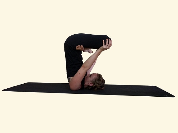 Sporty beautiful young man practicing yoga, sitting cross-legged in Adho  Mukha Padmasana, bending forward in variation of Lotus Pose on white Stock  Photo - Alamy