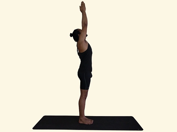 Young woman practicing yoga outdoors with hands raised up against blue sky.  Upward Salute pose. Rear view Stock Photo by ©Dmitry.Zimin 544269042